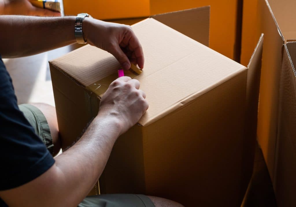 hand sealing parcel boxes at the warehouse distribution,